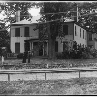 Portrait of Hetty Green, man and two workers and her residence