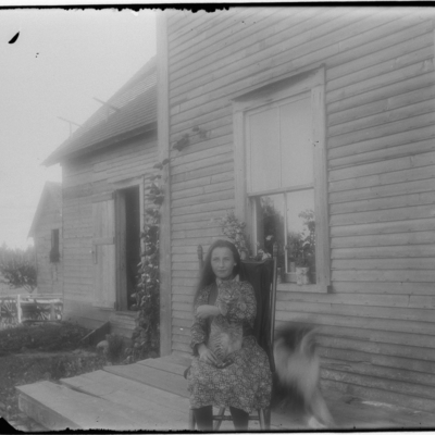Young Woman Holding Cat on Porch