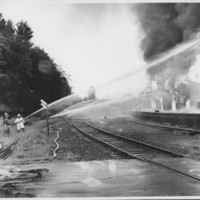 Removal of the B. and M. Freight House by Burning and as a Fire Fighter&#039;s Training Exercise. 7/12/1975. Hose Company on East Side.
