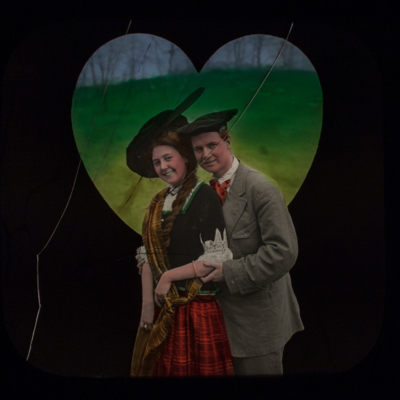 Man and woman standing in front of heart shape